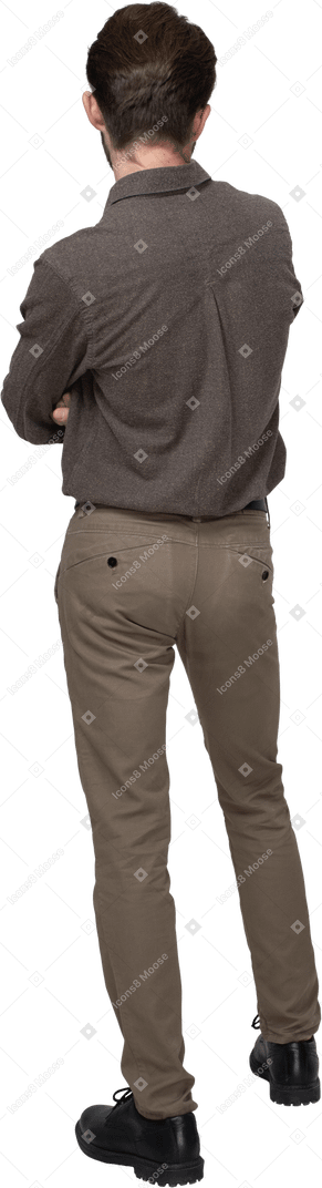 Back view of a young man in office clothing crossing arms