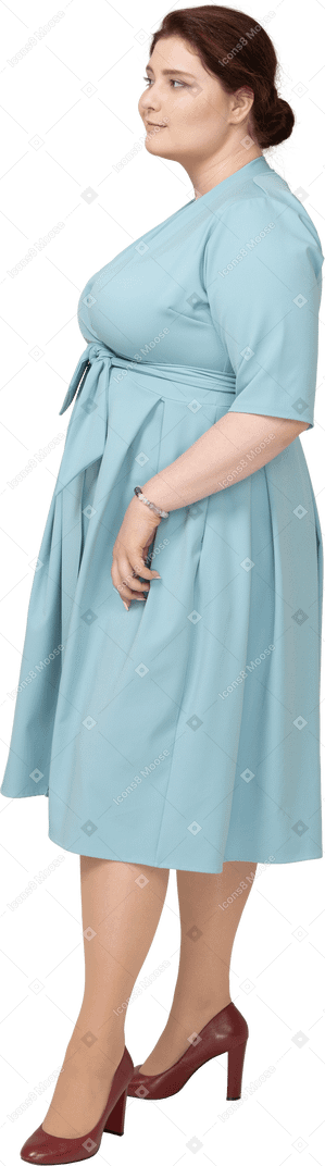 Woman in blue dress posing in profile