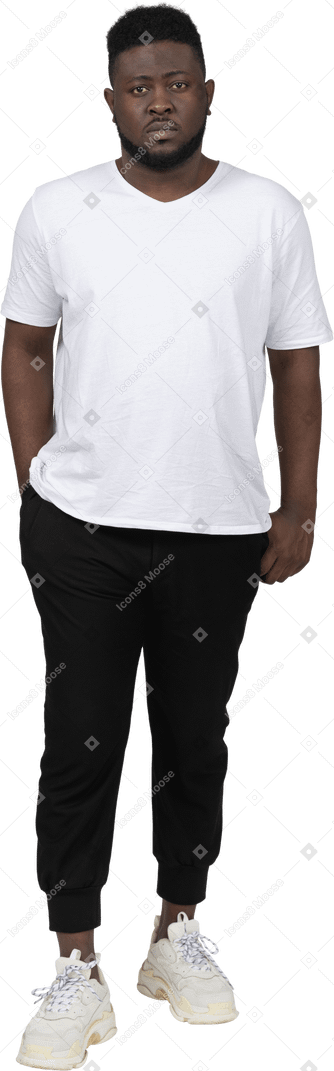 Front view of a young dark-skinned man in white t-shirt standing still