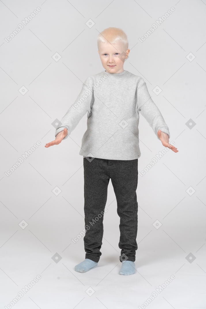 Little boy standing with spread arms