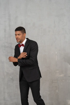Man in black suit posing