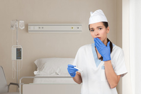 A nurse holding a thermometer