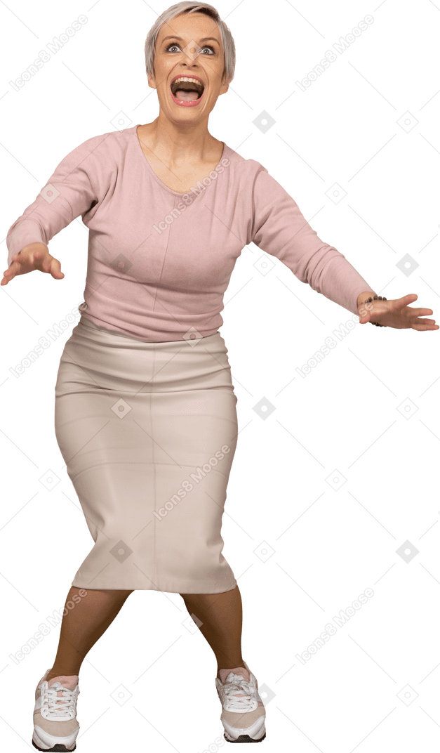Front view of a happy woman in casual clothes squatting and outstretching arms