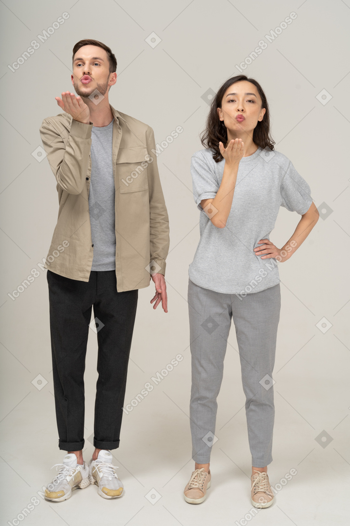Front view of young couple blowing a kiss