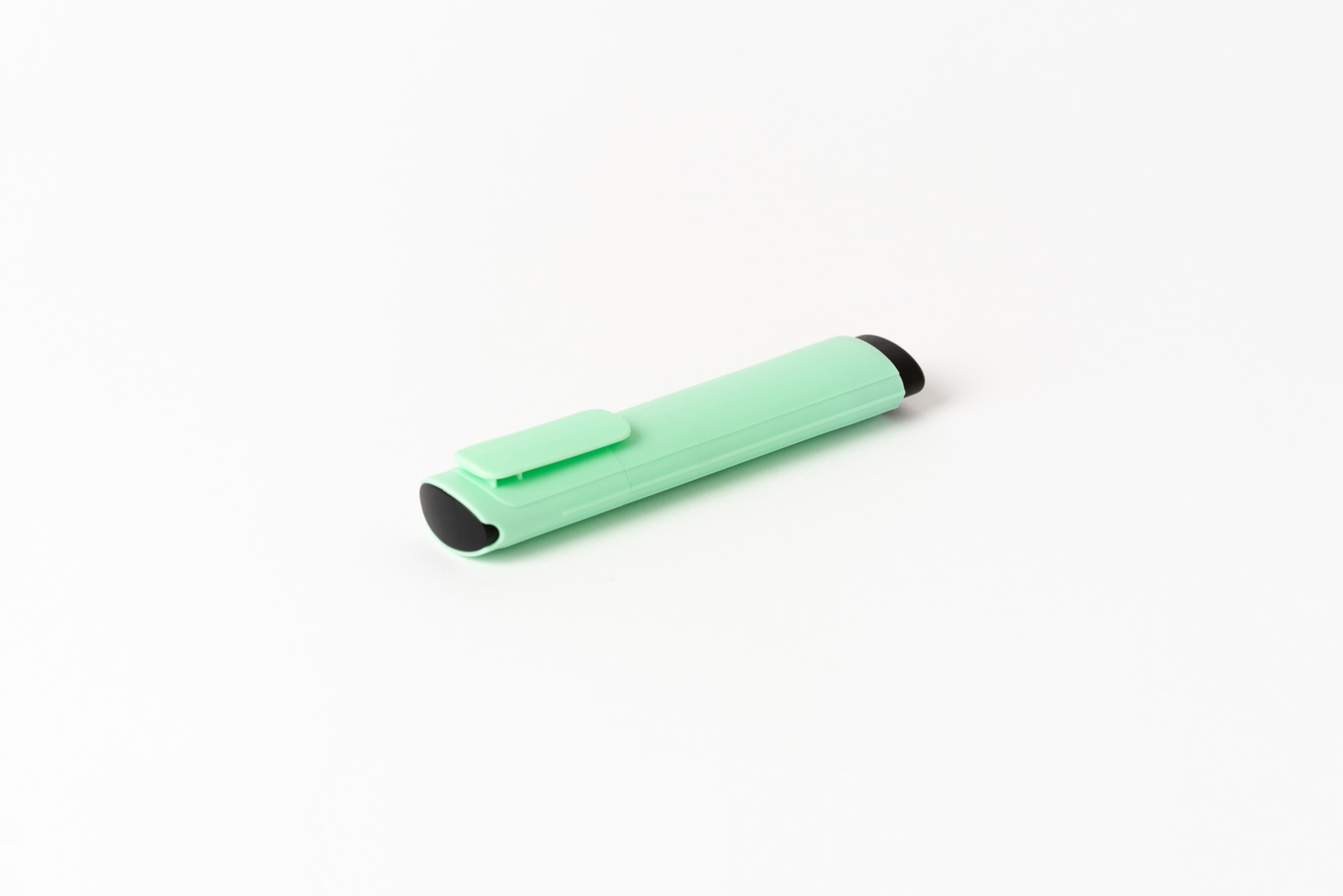 Green marker with green cap on white background