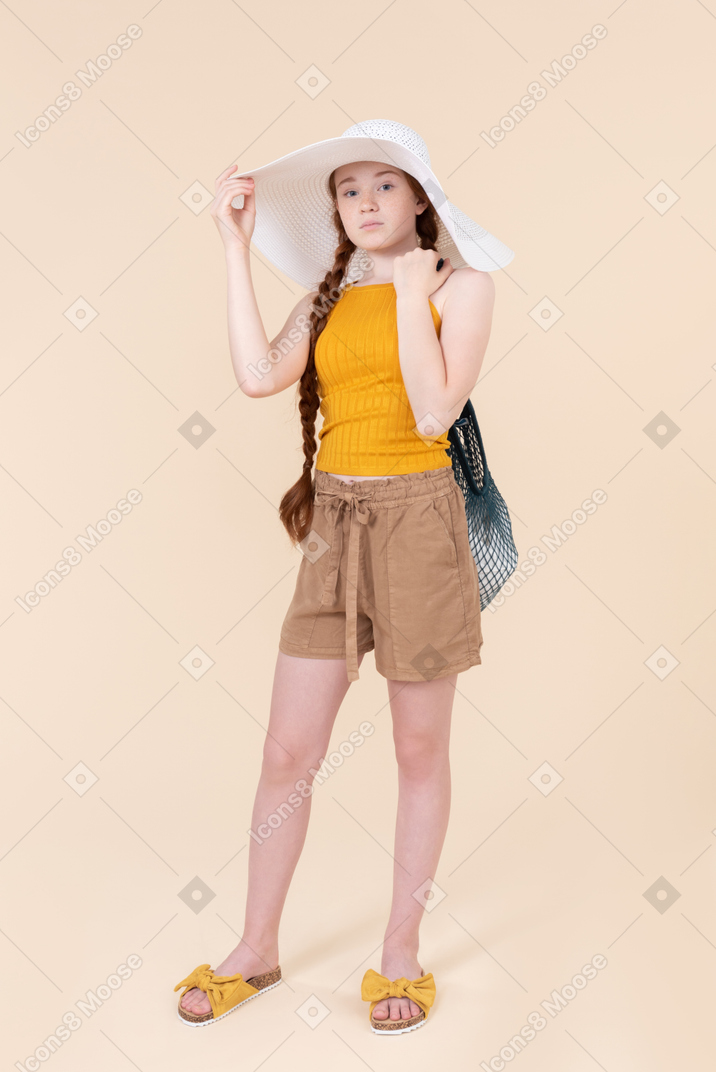 Teenage girl wearing white hat and holding avoska