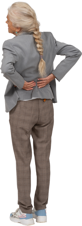 Rear view of an old lady in suit suffering from pain in lower back