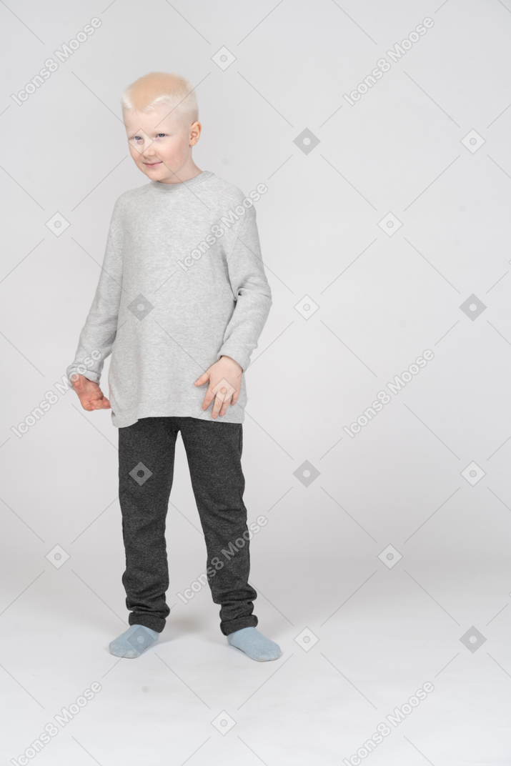 Little boy looking at camera and smiling lightly