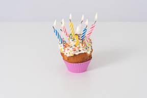 Cupcake with candles on a white background