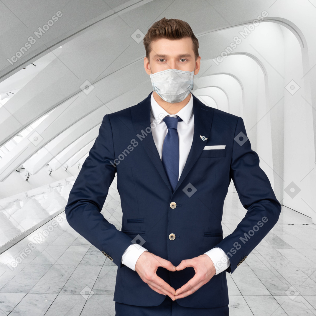 A flight attendant with a mask on his face