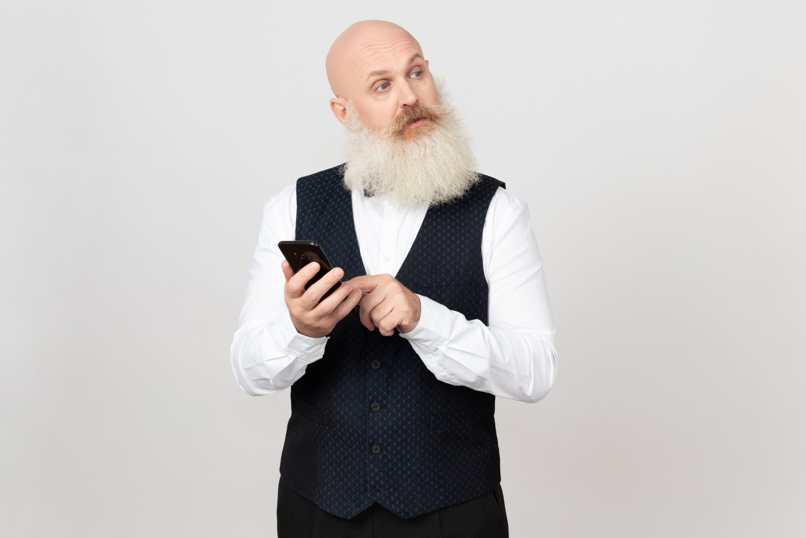 Aged man holding phone and looking aside