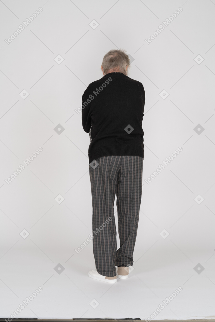 Back view of a standing old man