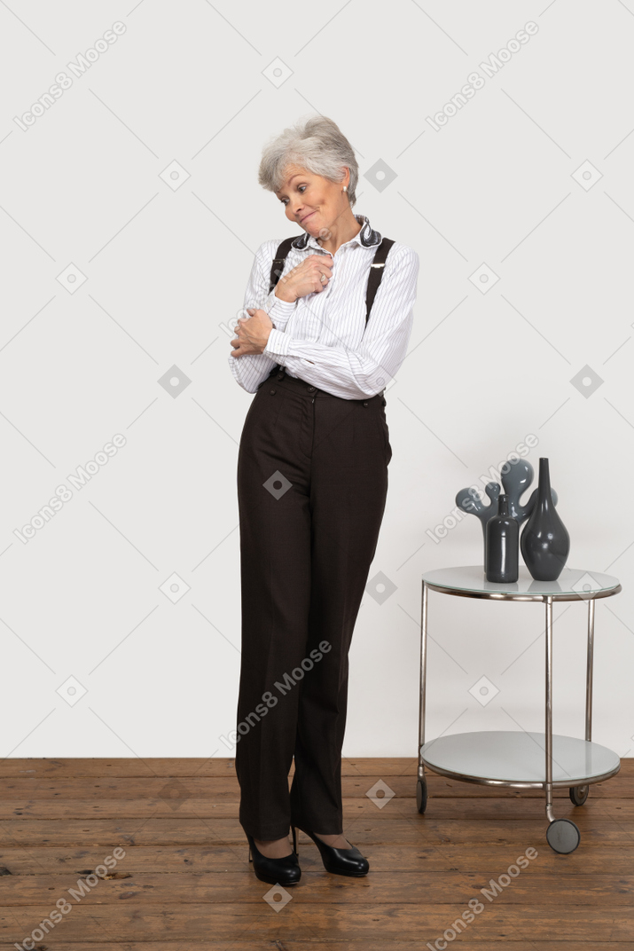 Front view of a confused old lady holding hands together