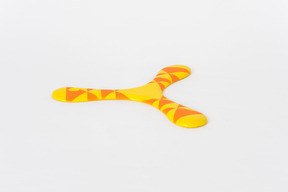 Orange and yellow boomerang on white background