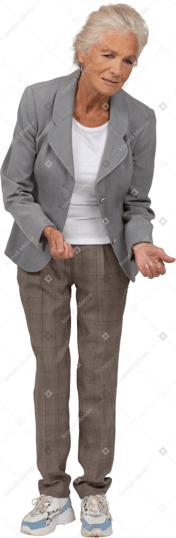 Front view of an old lady in suit bending down and explaining something
