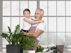 An older man holding a young boy in his arms