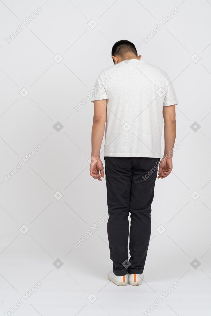 Back view of a man in casual clothes bending head down