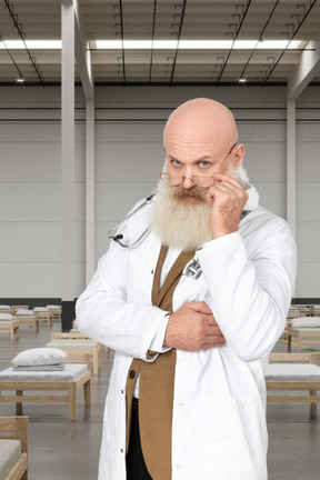 A man with a bald head wearing a lab coat