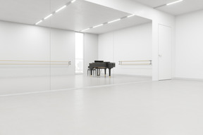 Sala vazia com barra de balé e um piano de cauda