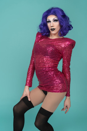 Portrait of a drag queen in pink sequin dress arching their back