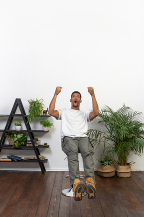 Good looking young man sitting on a chair