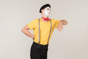 Male mime leaning on invisible object