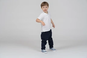 Three-quarter view of a boy looking slighly curious