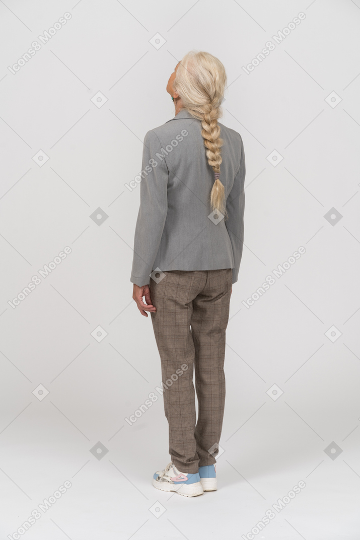 Rear view of an old lady in suit looking up