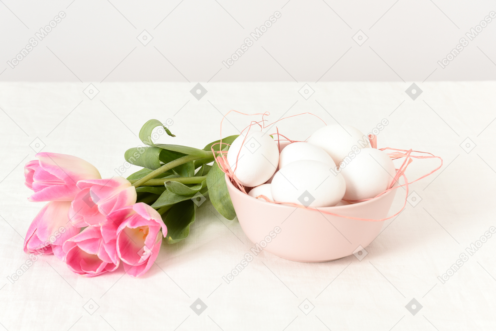A bowl with eggs and a tulip bouquet