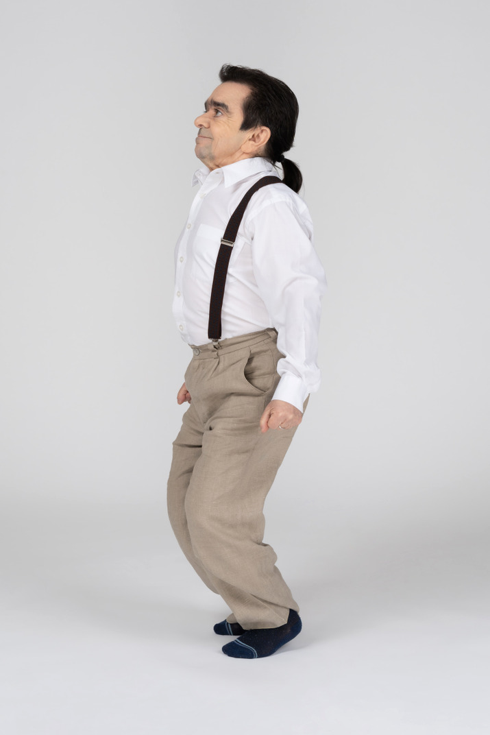 Middle-aged man in suspenders squatting