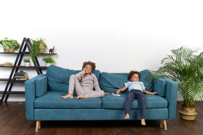 Good looking boy and girl play on the sofa