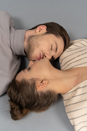 Close-up of a couple kissing while lying down