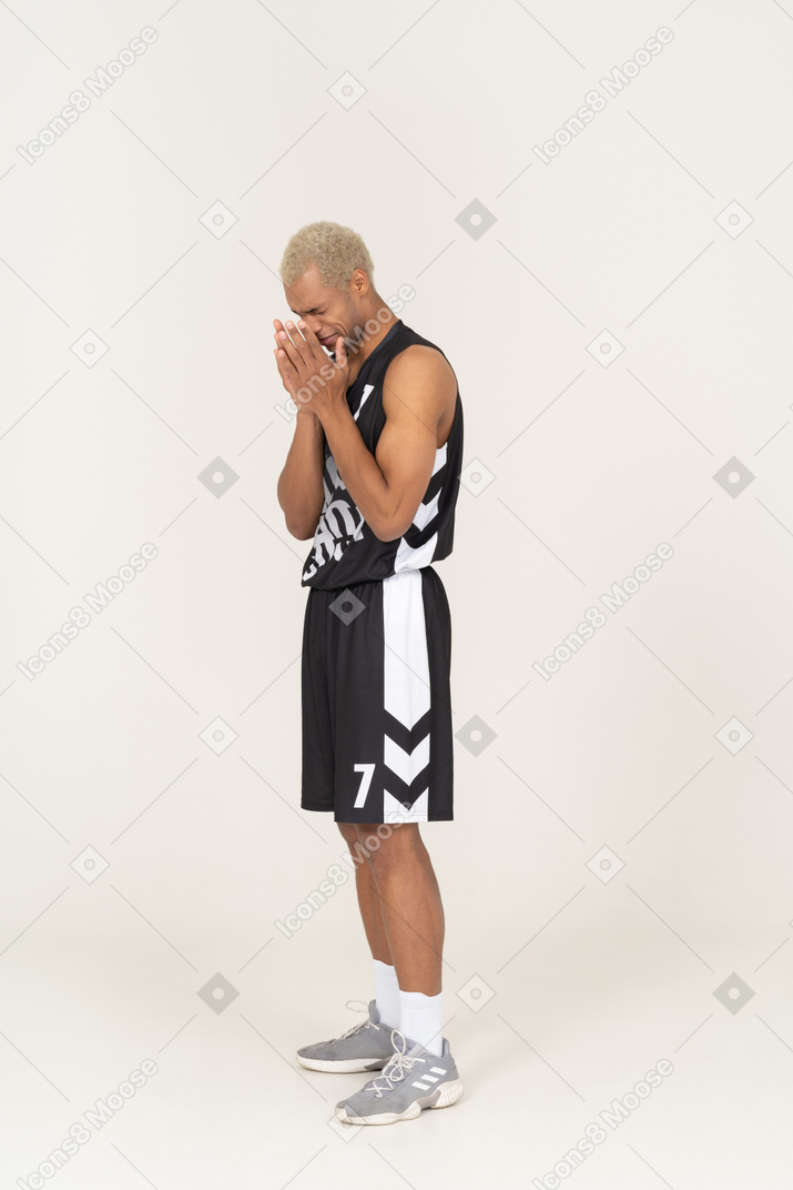 Three-quarter view of a crying young male basketball