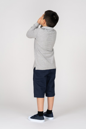 Boy covering his eyes
