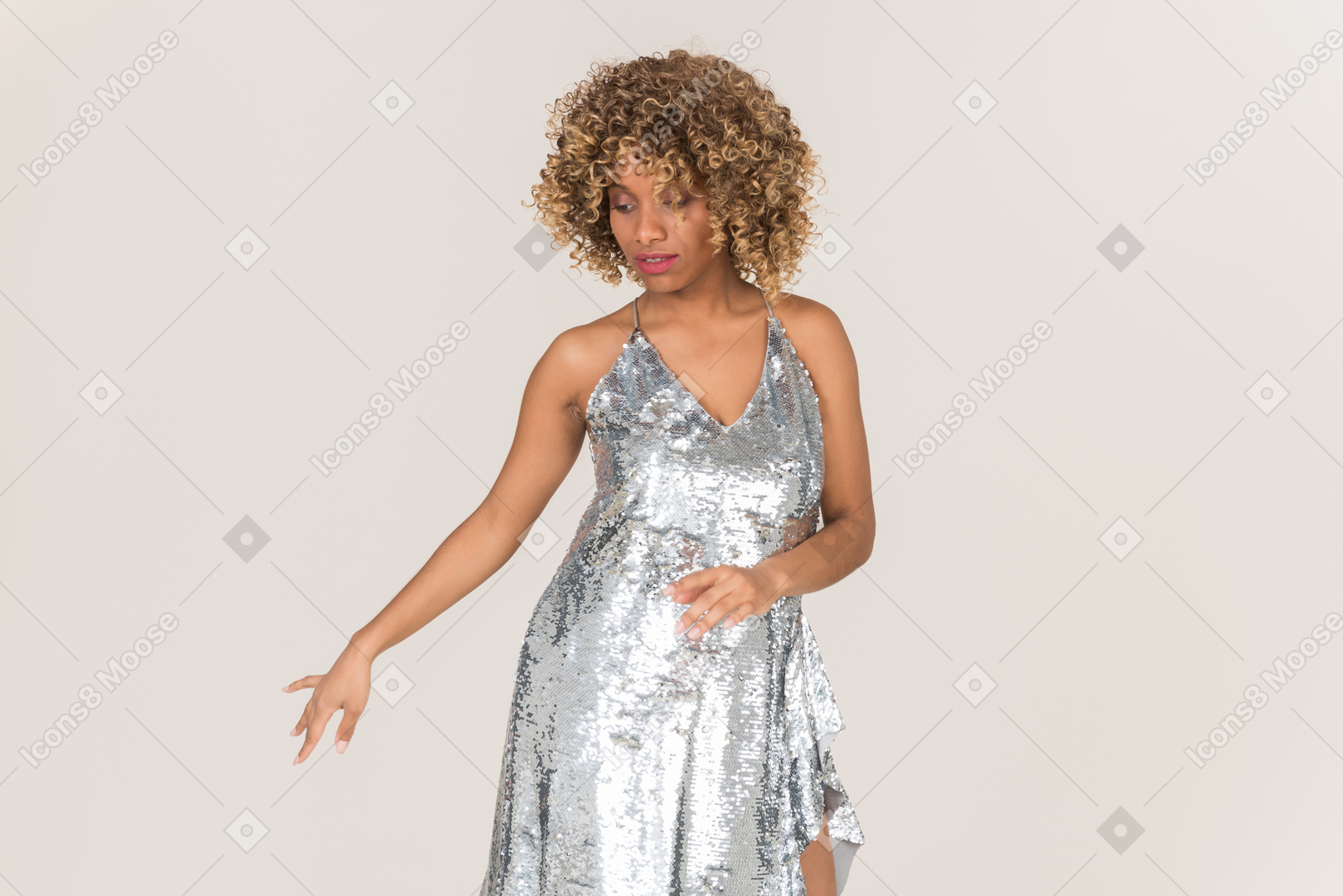 Young woman in shining grey dress dancing