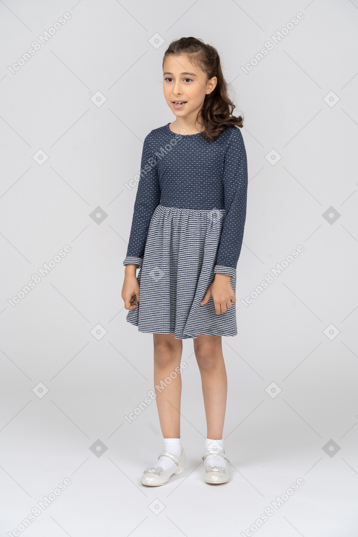 Three-quarter view of a girl smiling awkwardly