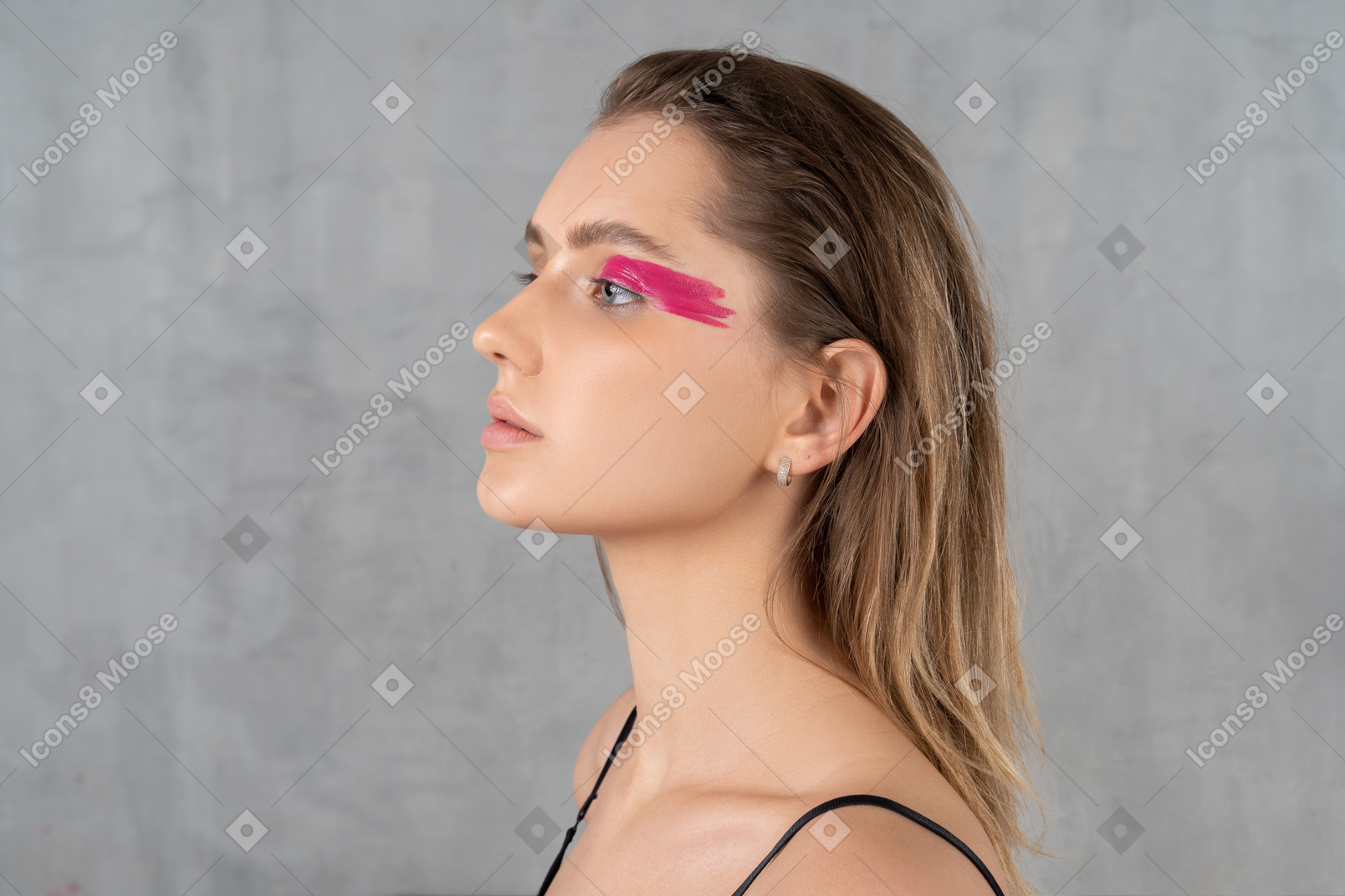 Headshot of a beautiful young woman with bright pink eye make-up