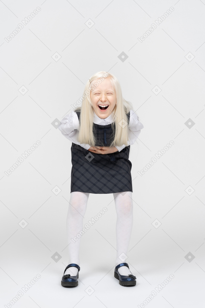 Schoolgirl laughing hard and grabbing stomach