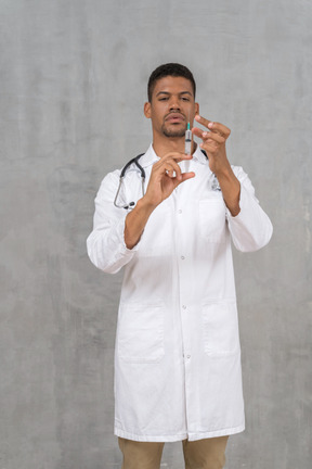 Male doctor preparing a syringe