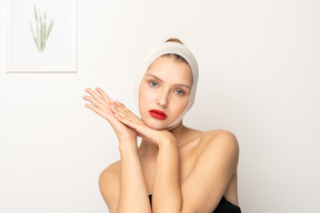 Woman with head bandage holding her hands together