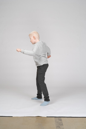 Side view of a boy walking carefully