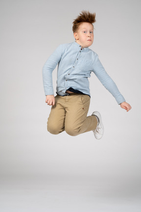 A boy jumping high in the air