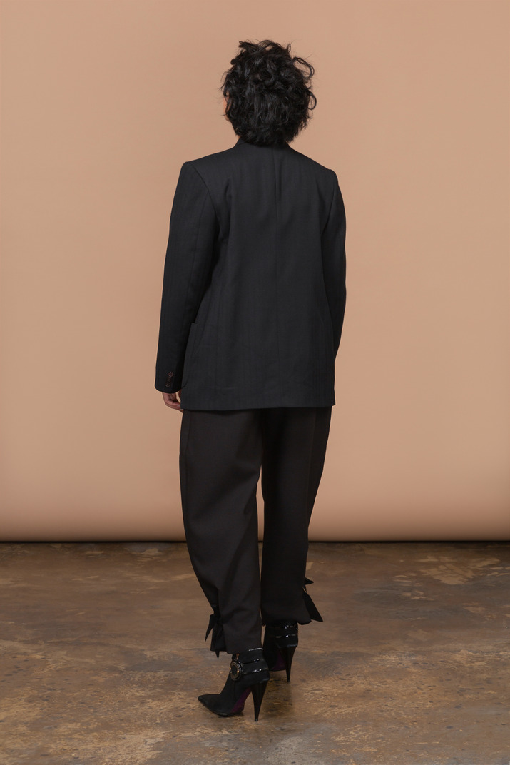 Back view of unrecognizable woman wearing black suit