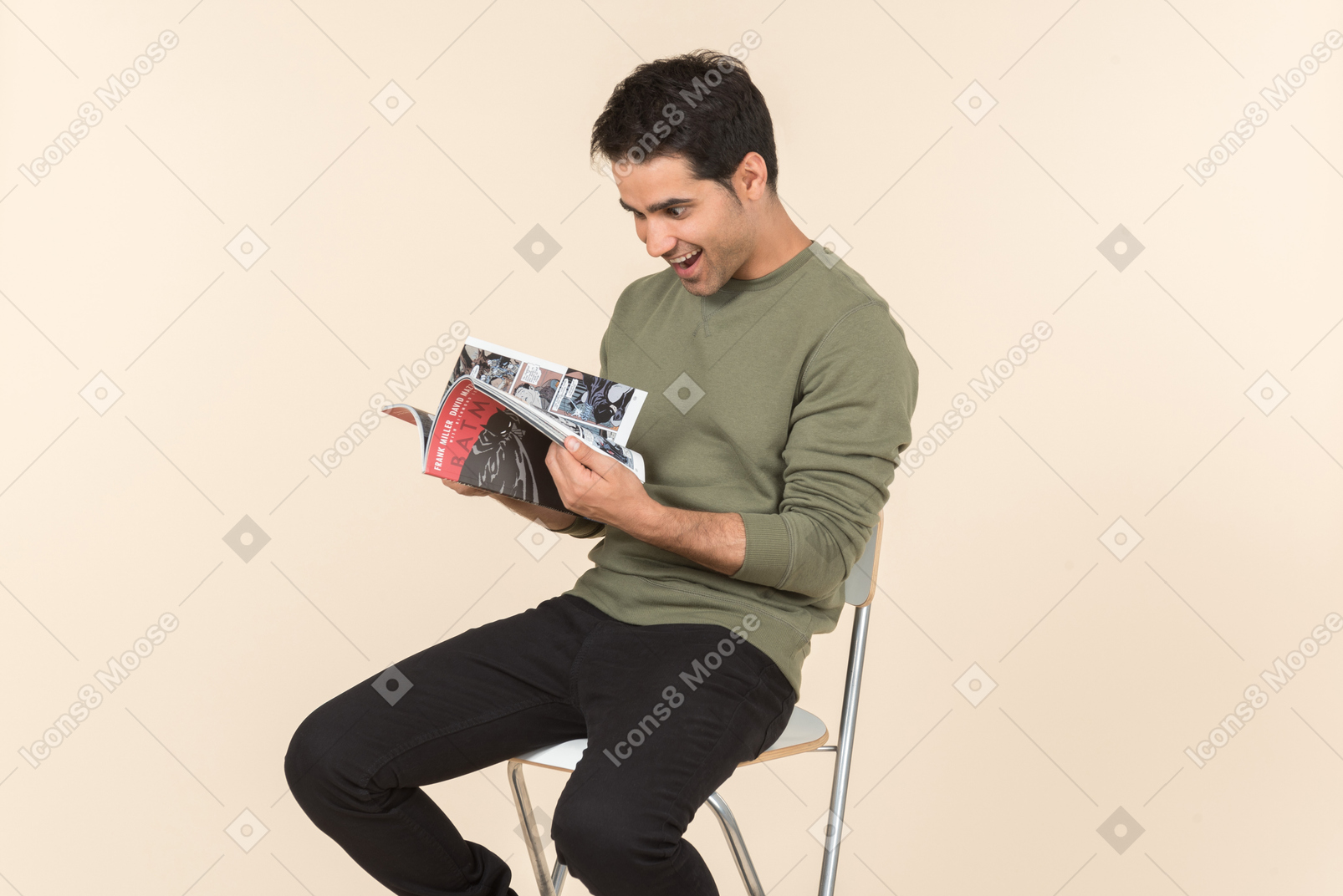 Young caucasian guy reading a comicbook