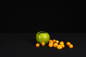A composition of an apple, cherry tomatoes and leeches