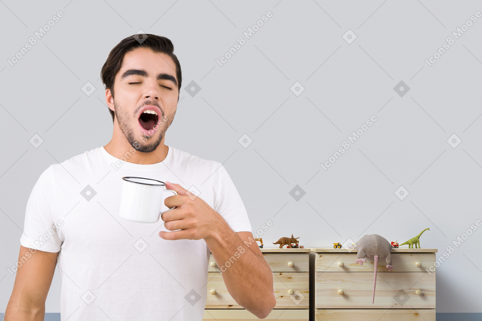 Yawning man holding a cup of coffee
