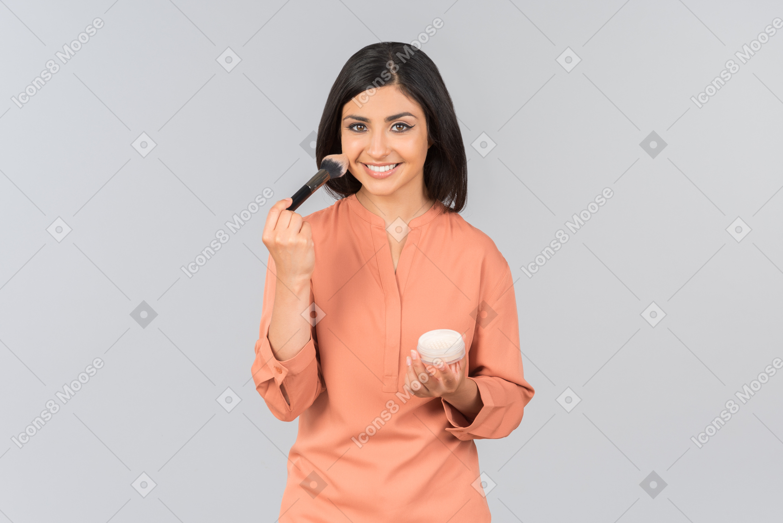 Indian woman applying face powder on her face
