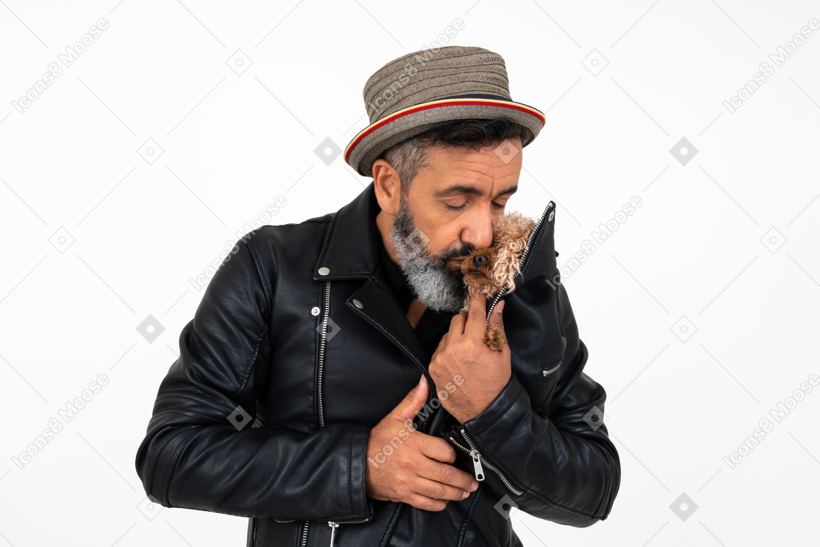 Man kissing a puppy which he's holding under the jacket