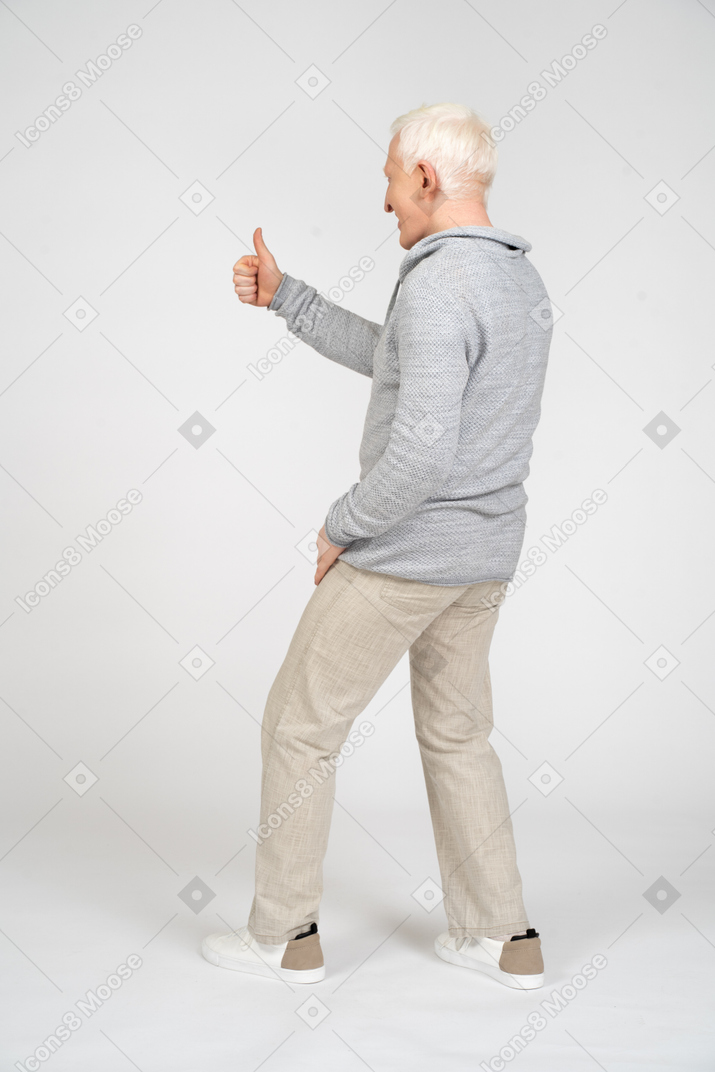 Side view of man giving thumbs up