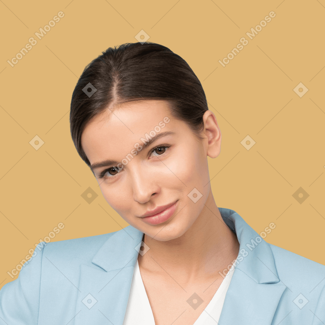 A young woman in a blue blazer posing on a yellow background